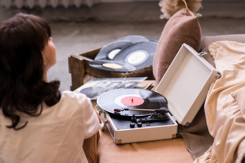 nostalgia de vintage. femeie care asculta muzica la pick-up